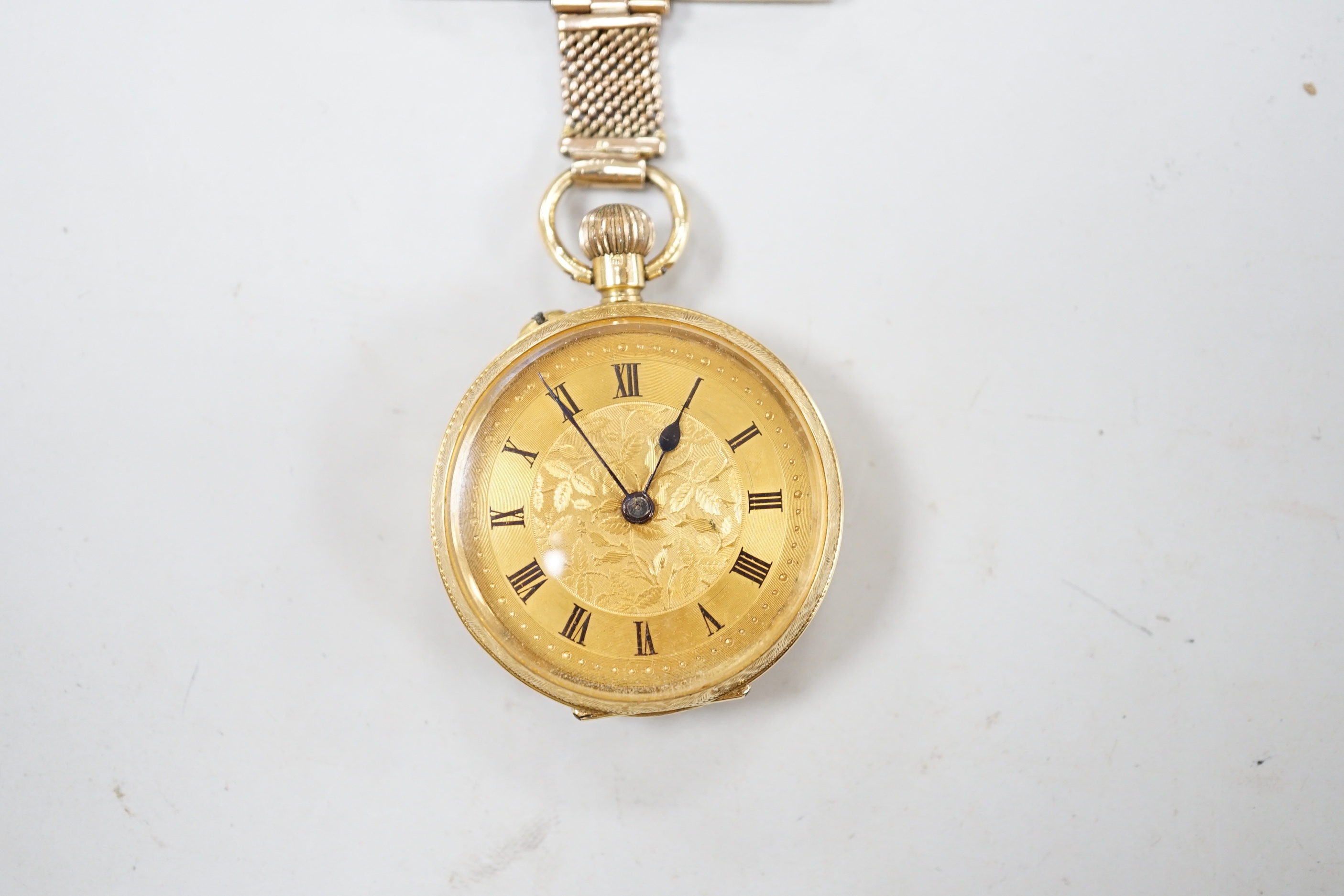 An early 20th century 18ct gold open face fob watch, with Roman dial, on a 9ct suspension brooch, gross weight 27.5 grams.